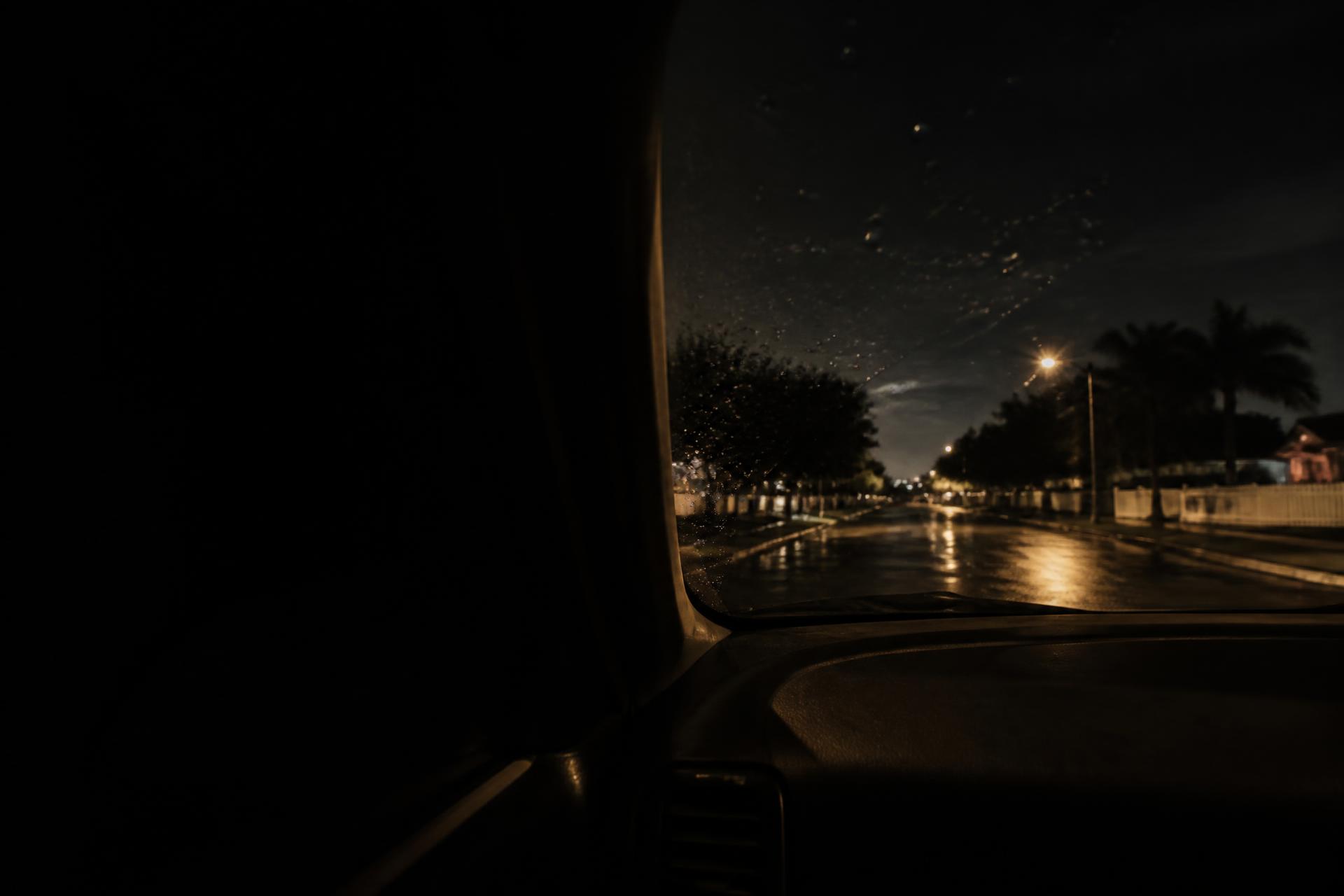 Night surveillance view of a quiet Florida street from inside a parked vehicle